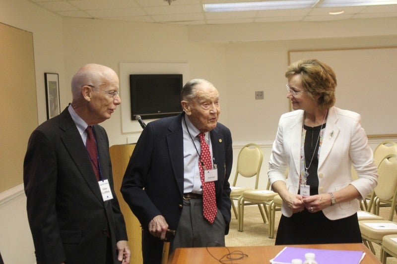 Aspen Wye Fellow and Moderator Alan Griffith, left, and Judy Price, Manager, Aspen Wye River campus, right, confer with Jack Bogle before his presentation.