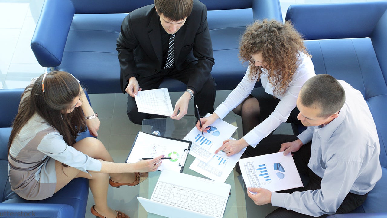 Top view of working business group sitting at a table during a corporate meeting