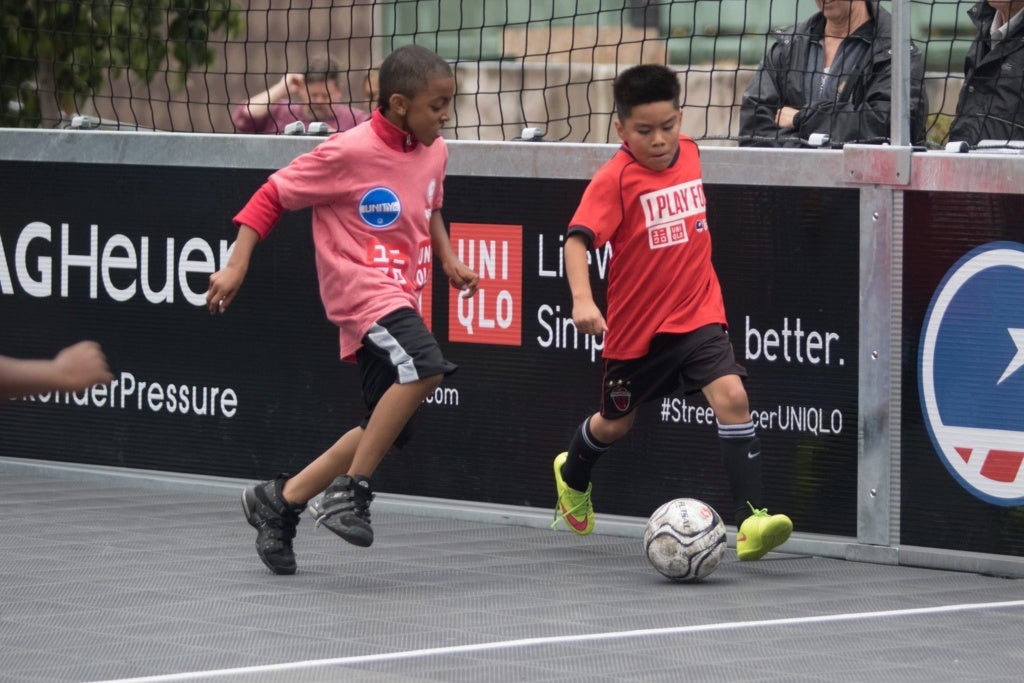 Latino youth dribbling soccer ball