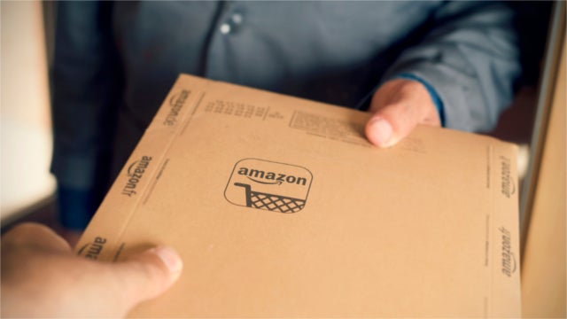 Person holding an Amazon package