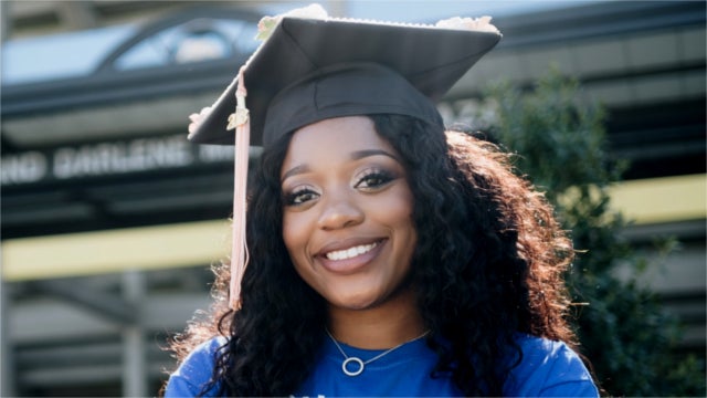 Woman in graduation cap.