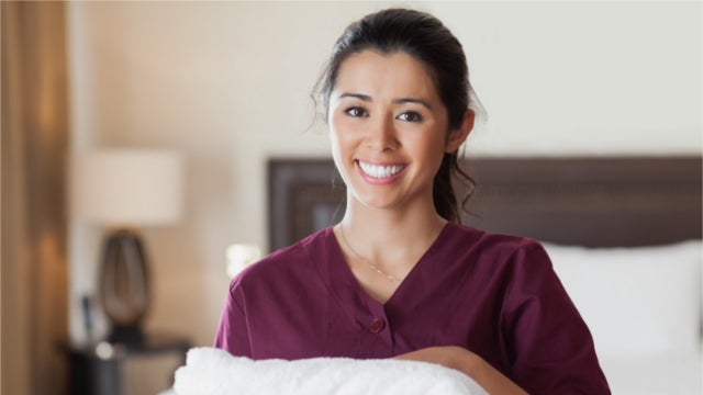 Hotel maid holding a towel