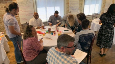 Fellows from the New Orleans Workforce Leadership Academy meet in person