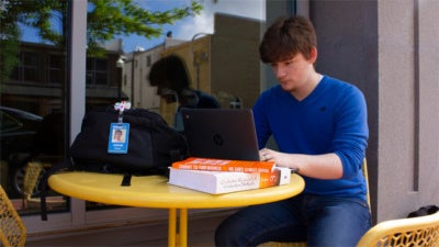High school student working on laptop