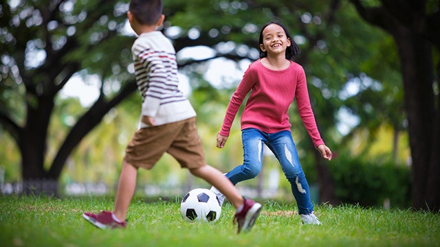 Kids playing soccer outside