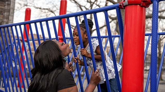 Black mom and child on playground