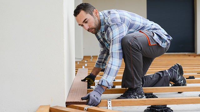 Person installing hardwood flooring