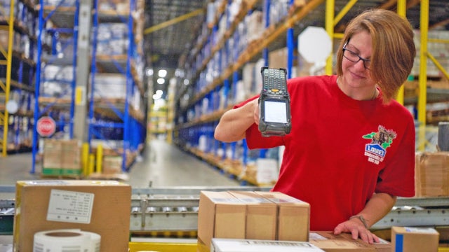Photo of a Lowe's employee scanning a box in a warehouse