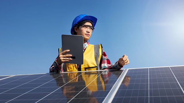 Female engineer working on solar panels