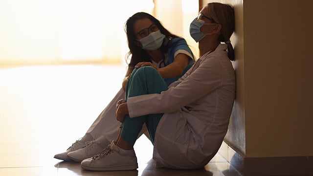 Stressed health care workers in hospital hallway