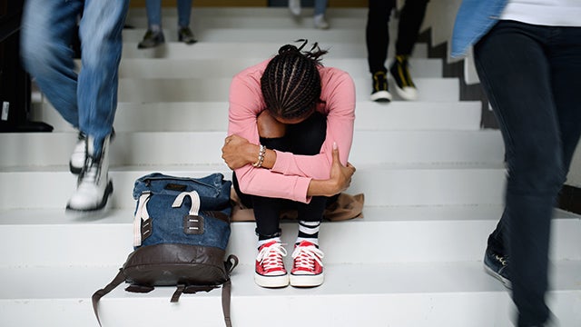Sad Black student on school steps