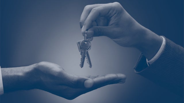 Photo of two hands exchanging a set of keys