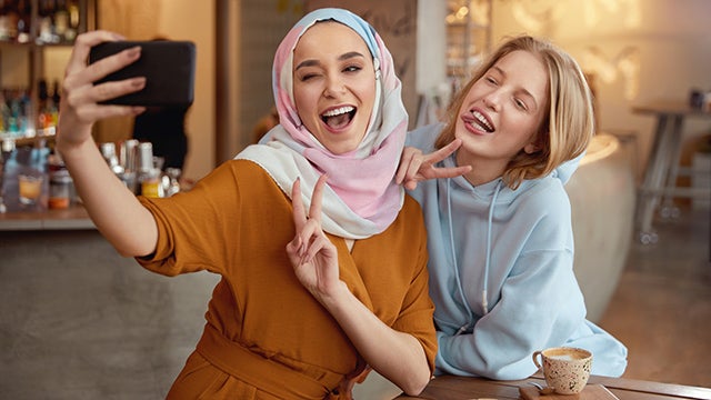 Muslim and Christian girls take a selfie