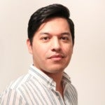Headshot of with black hair and white and gray striped shirt on beige background