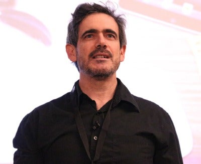 Headshot of man with black hair looking upward 