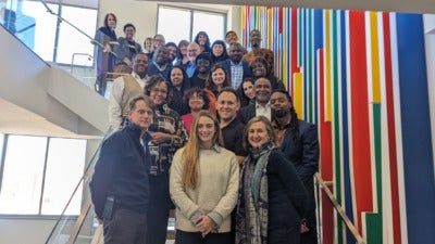 A photo of Aspen Institute staff with staff of CDFIs participating in the Institute's Shared Success demonstration. The group is standing on the stairs of the Institute's Washington DC office.