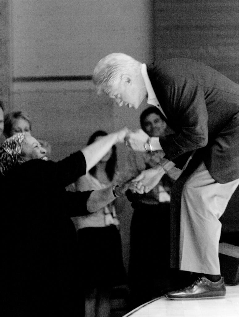 Bill Clinton kisses the hand of Maya Angelou in Harris Hall at the Aspen Ideas Festival 2005. 
