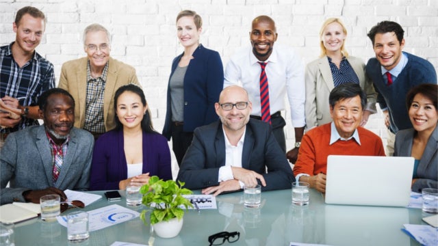Group of employees sitting at a conference table