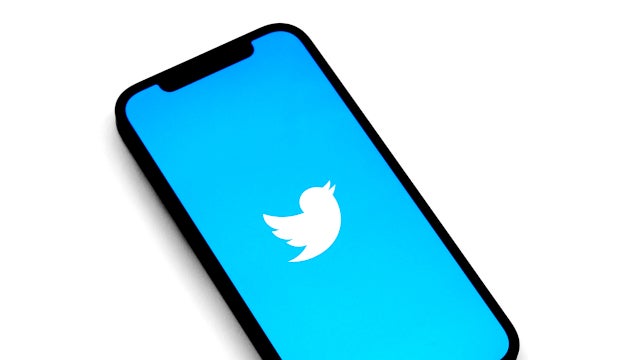 Photo of a smartphone with the Twitter logo on screen. Photo by Jeremy Bezanger on Unsplash.