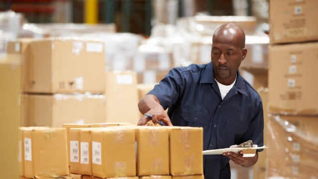 Photo of warehouse worker preparing goods for dispatch