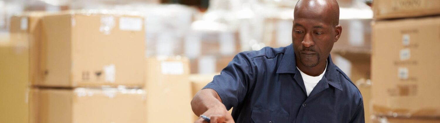 Photo of warehouse worker preparing goods for dispatch