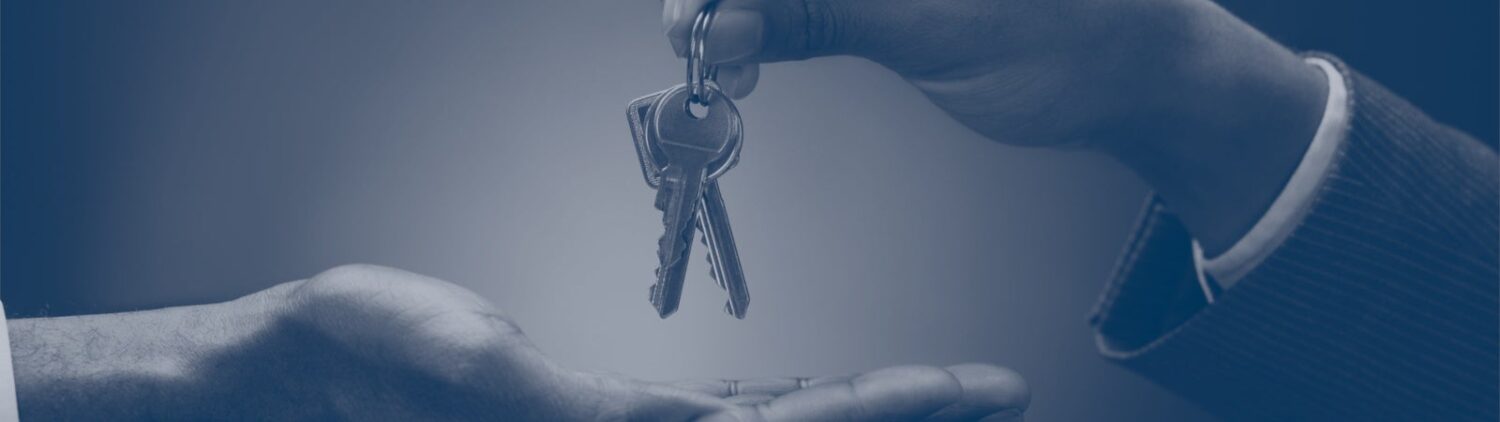 Photo of two hands exchanging a set of keys
