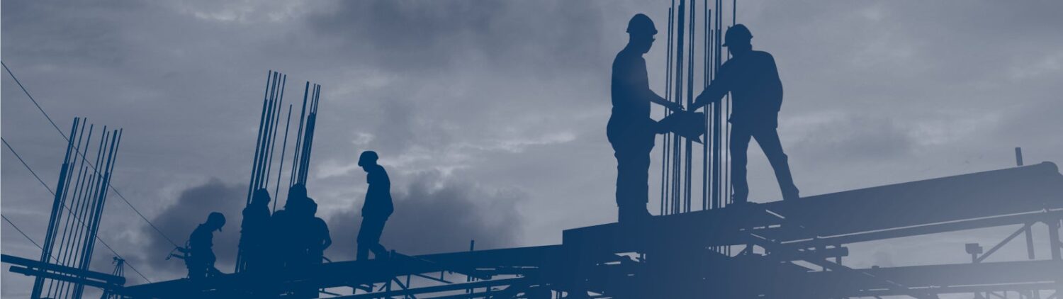 Silhouette image of construction workers standing on scaffolding