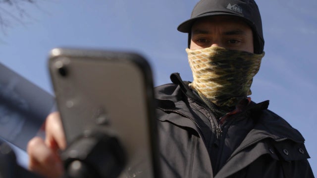 Gig worker Diego Gerena-Quiñones scrolls through his phone