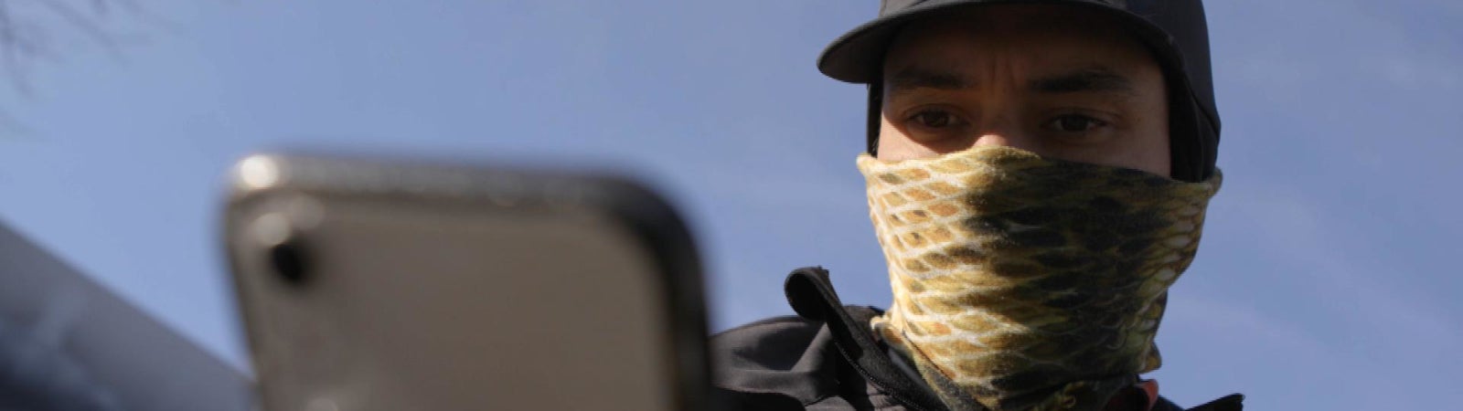 Gig worker Diego Gerena-Quiñones scrolls through his phone