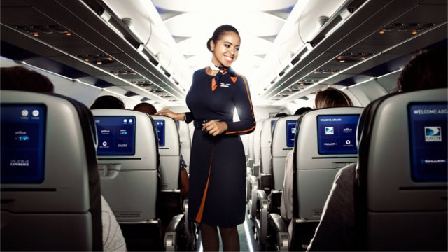 Smiling JetBlue crewmember in airplane