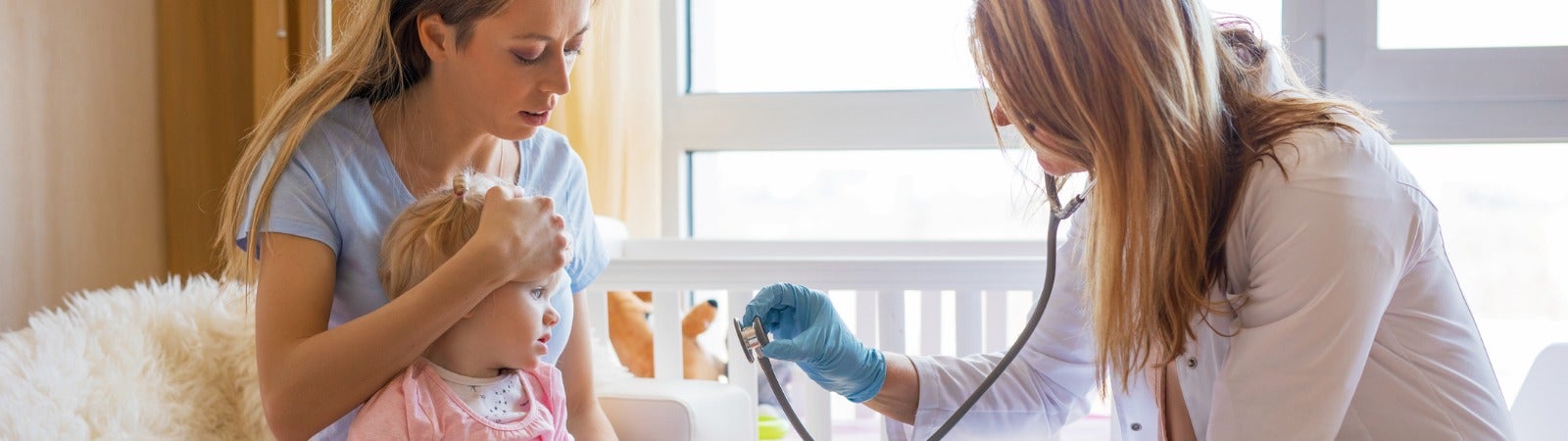 A pediatrician with a baby and her mother.