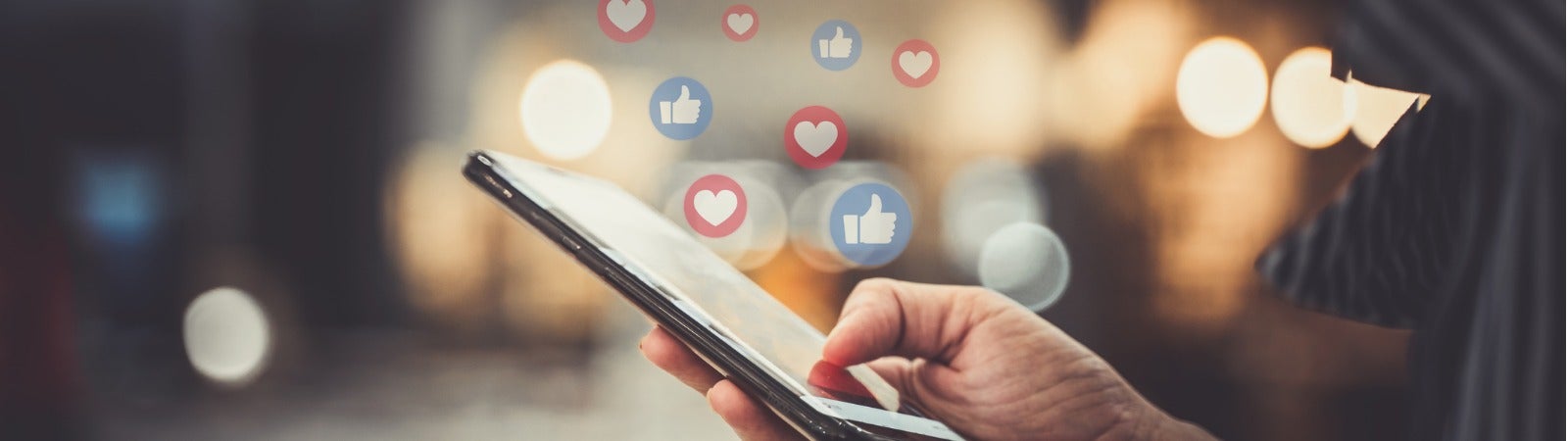 A person holding their phone and receiving social media notifications.