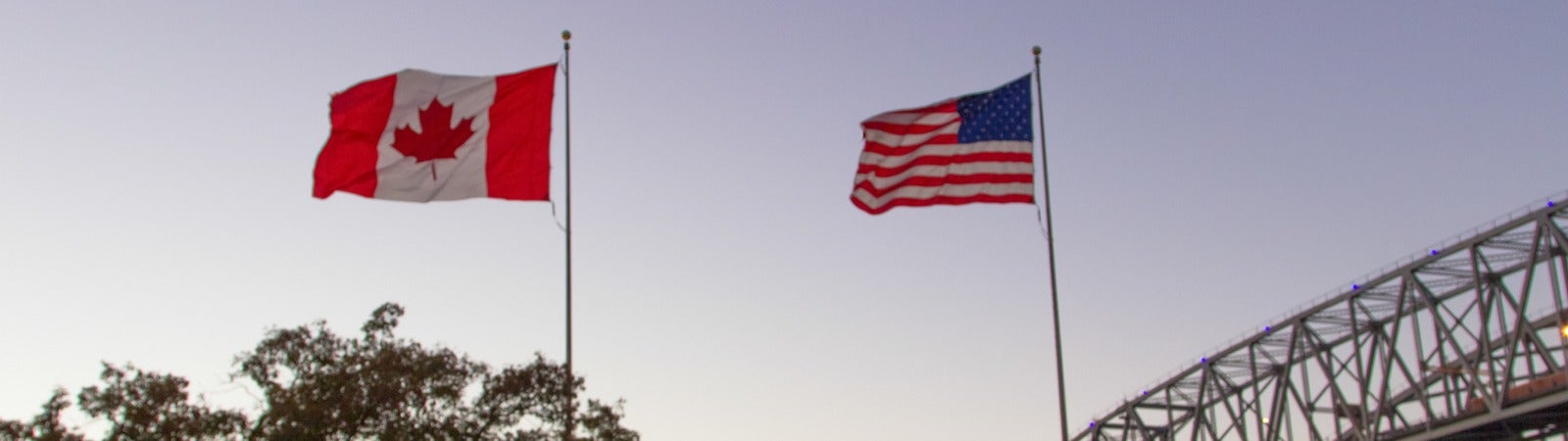 The Cnadian and American flags flying at the International Blue Water Bridge Crossing.