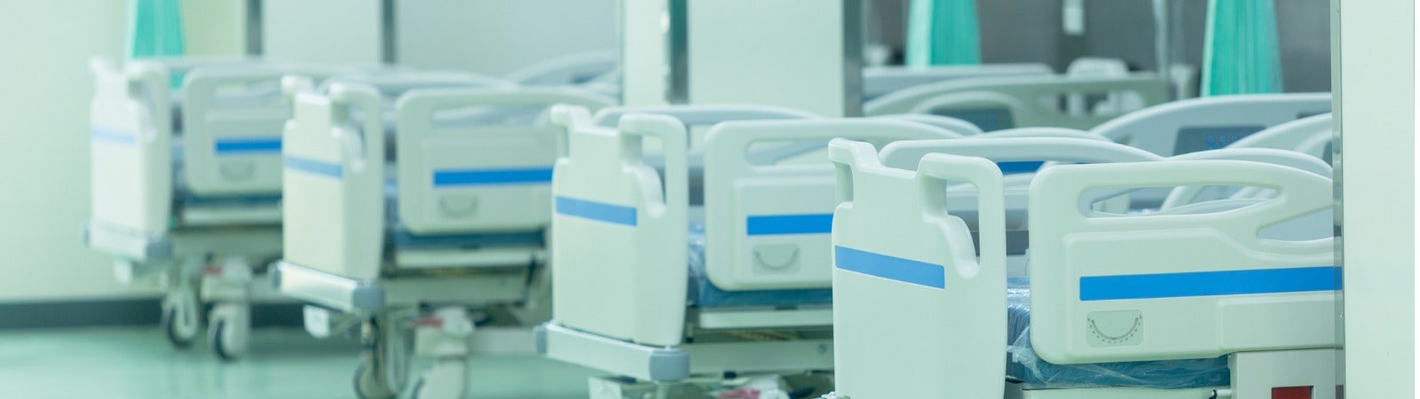 A row of patient beds in a hospital.