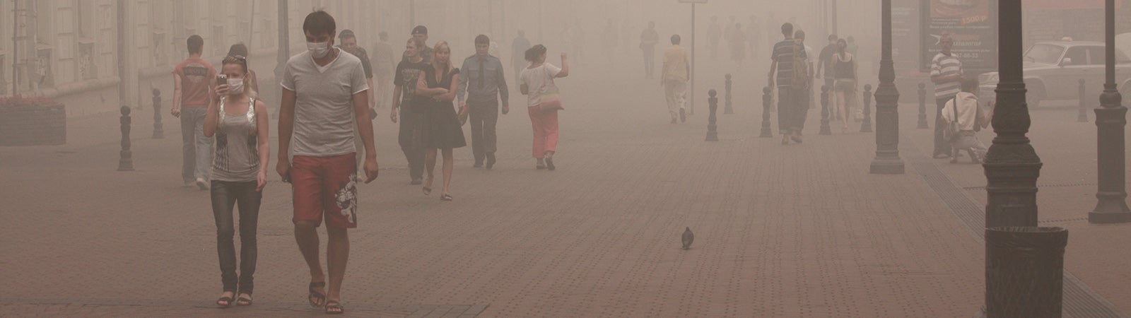 People in city street filled with smog