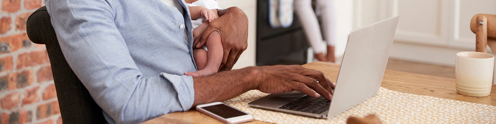 Two people holding pens over a page of charts and graphs