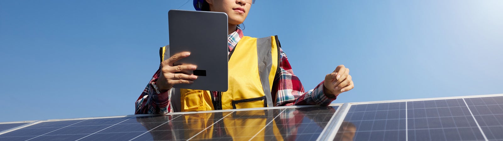 Female engineer working on solar panel