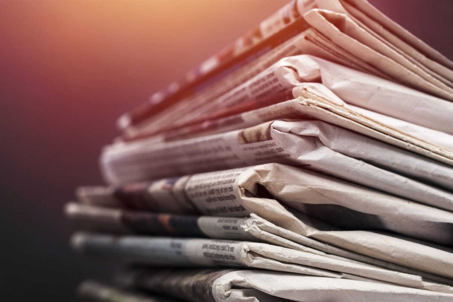 A photograph of a stack of newspapers.