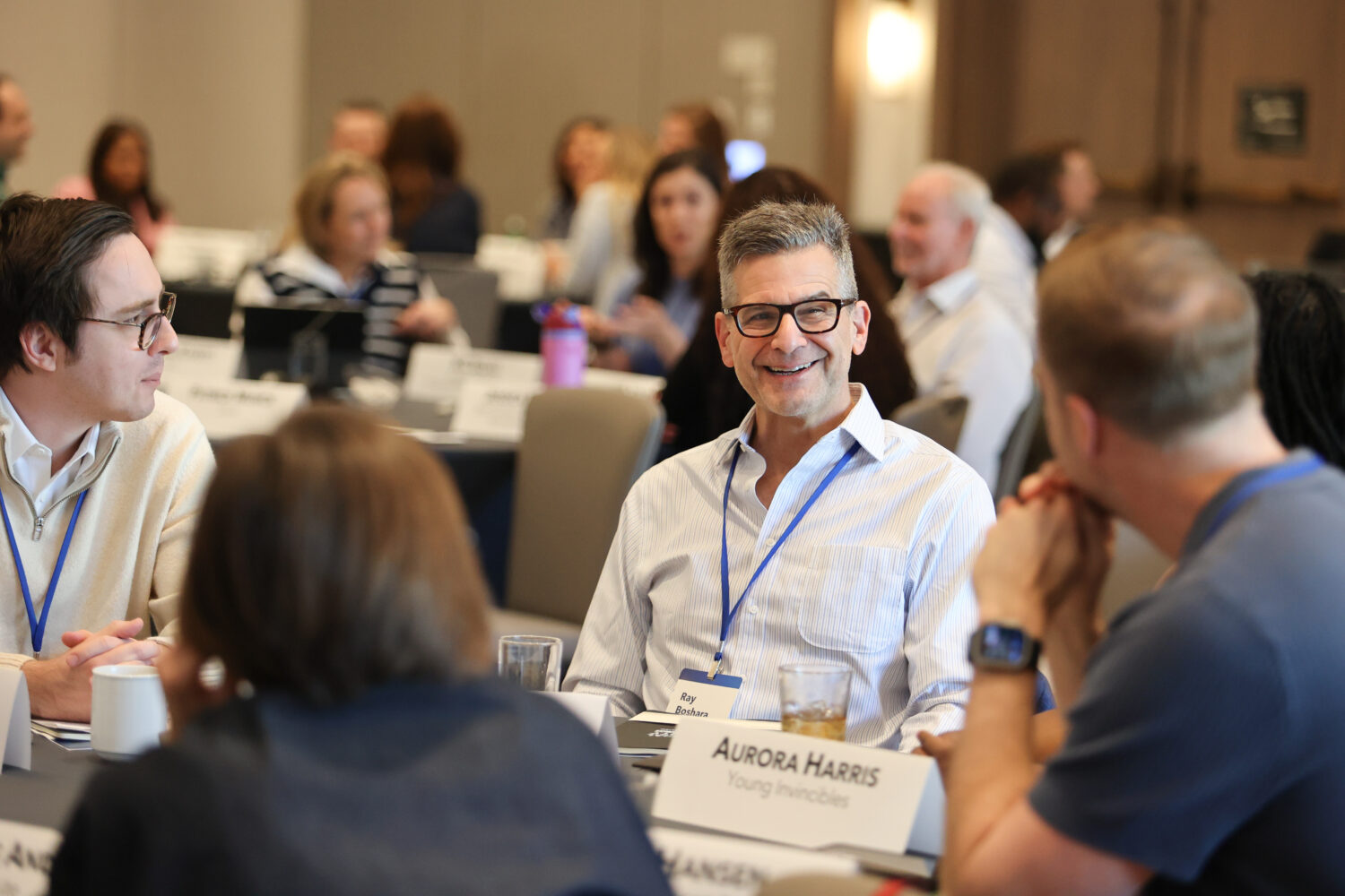 Ray Boshara sits at a table with other event attendees