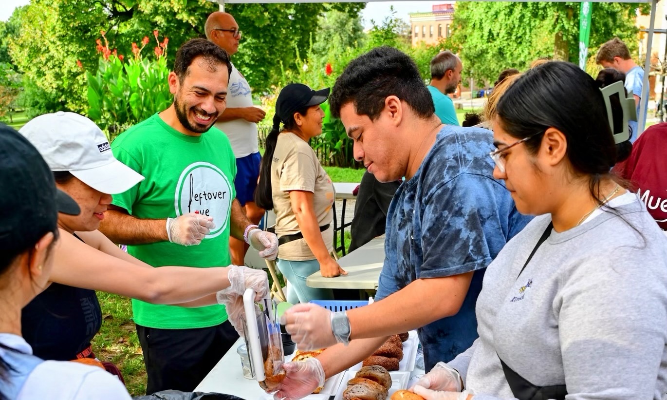Omar Tarabishi (in green) and friends share leftover food at an event to inspire more people to help recover and distribute food that would typically be thrown out. Photo credit: Omar Tarabishi