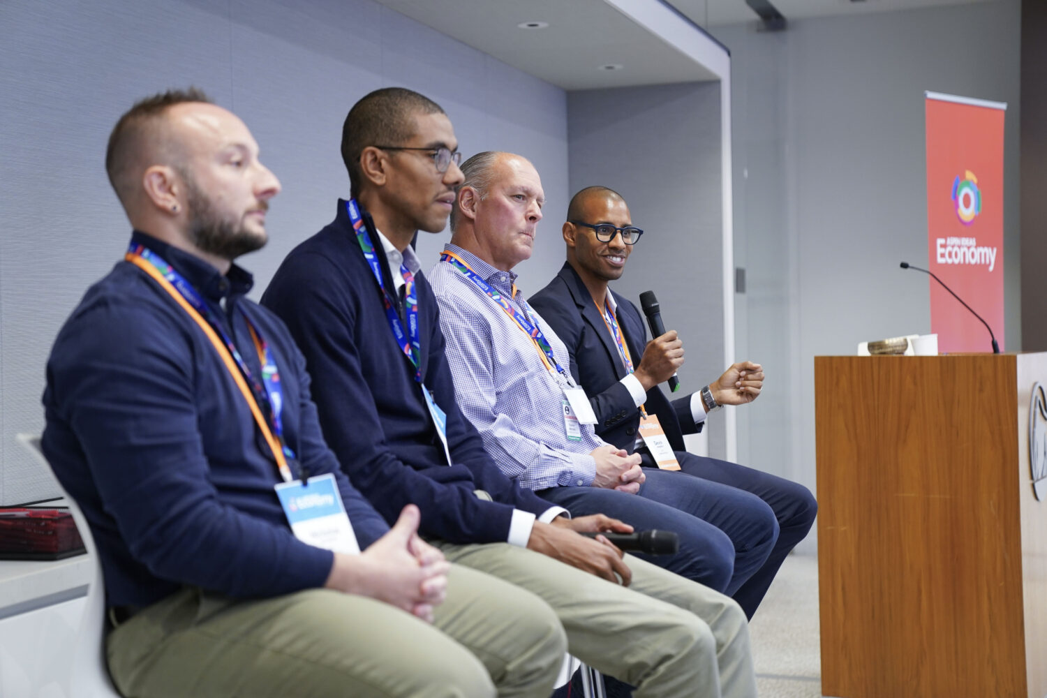 Four panelists sit behind a podium at Aspen Ideas: Economy.