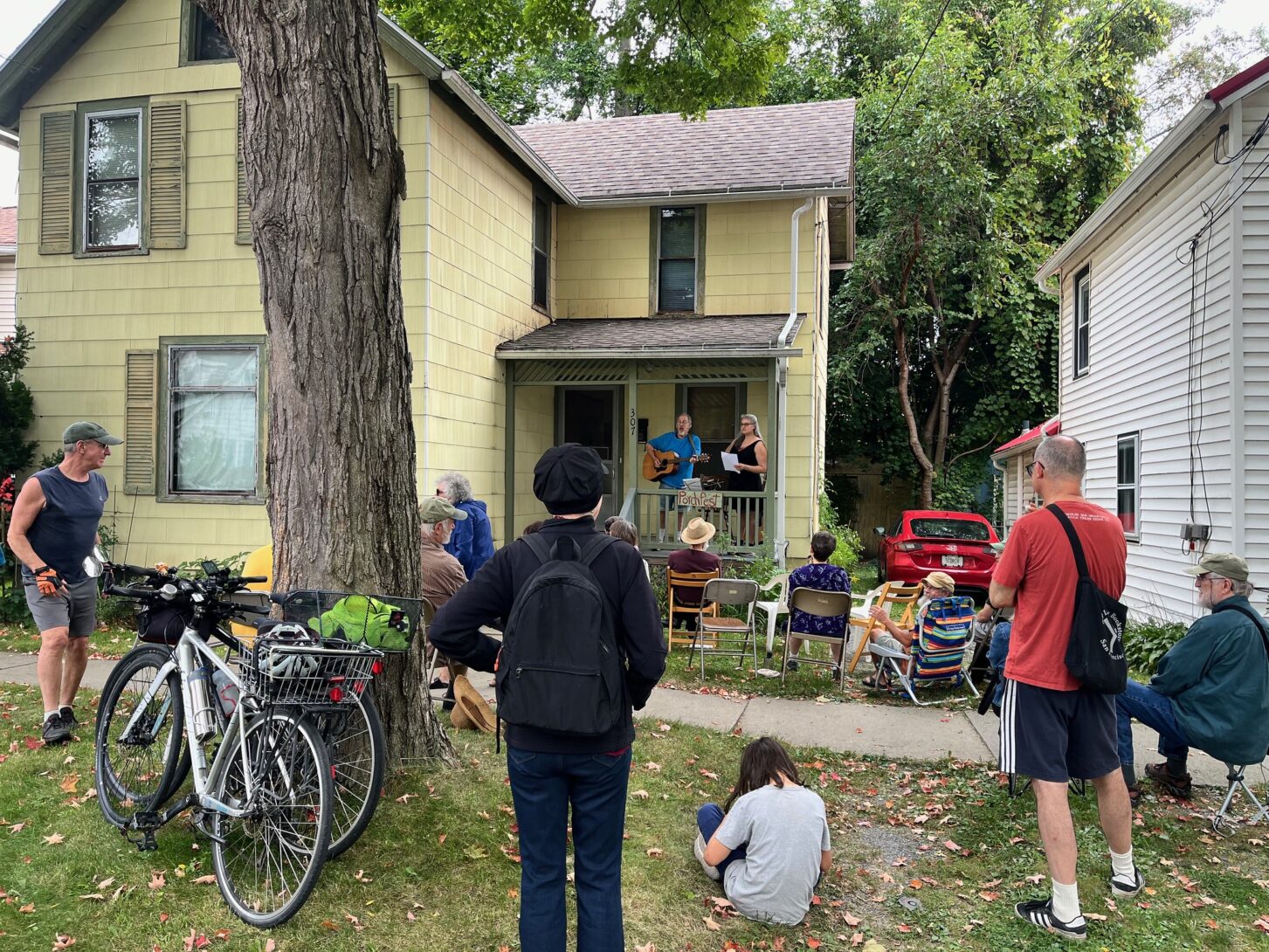 Neighbors enjoying a community meal and shaking hands. Photo credit: Andy Clayton-King