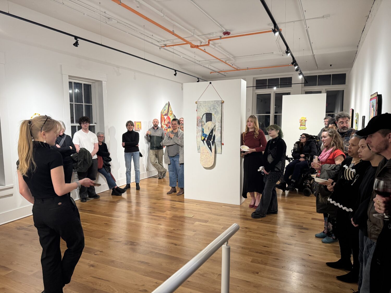 Curator Eddie Frank speaks at the opening of Papercuts: Overlapping Perspectives, an art exhibition at Maybe It's Fate Cooperative. Photo credit: MaybeItsFate Cooperative.