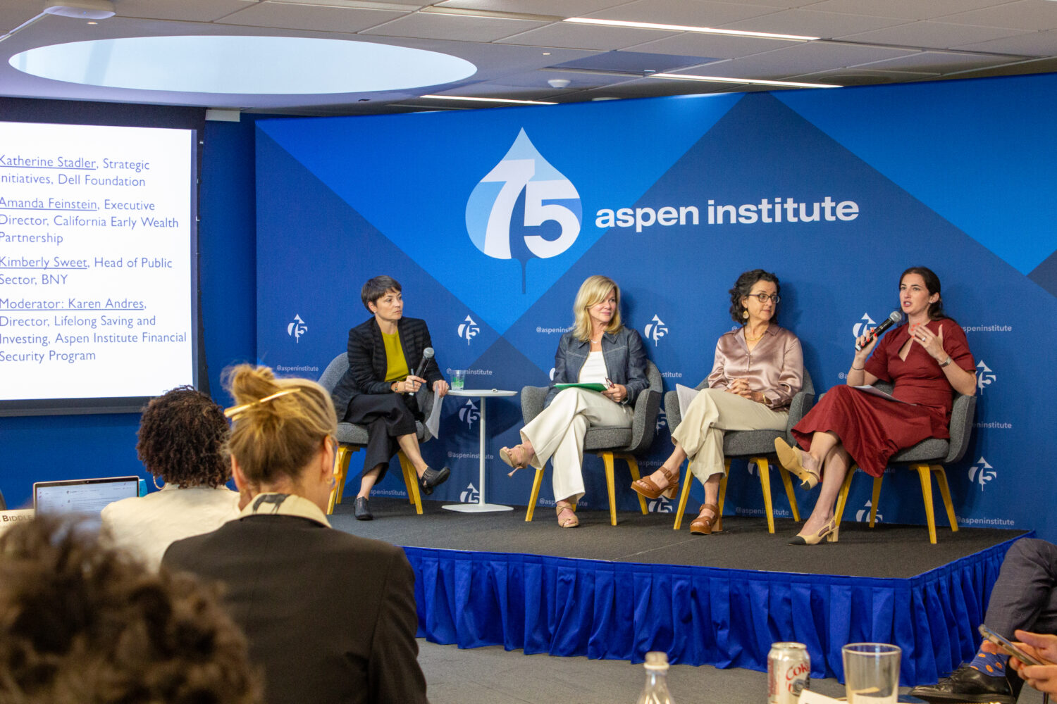 Four panelists sit on a stage in front of an Aspen backdrop.