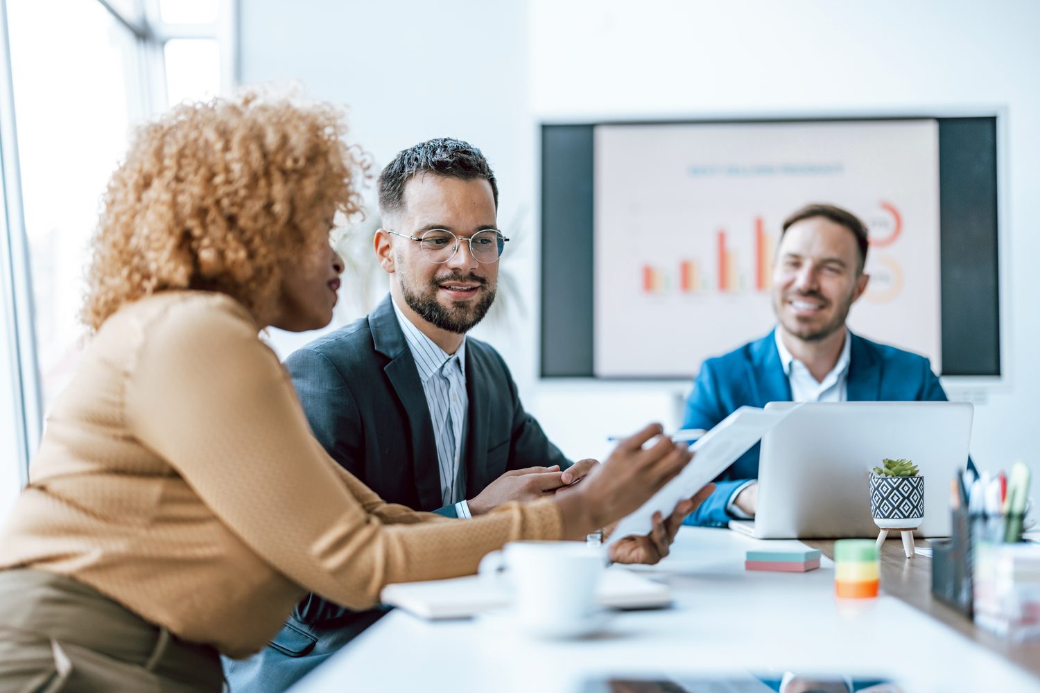 Three business professionals discuss data trends